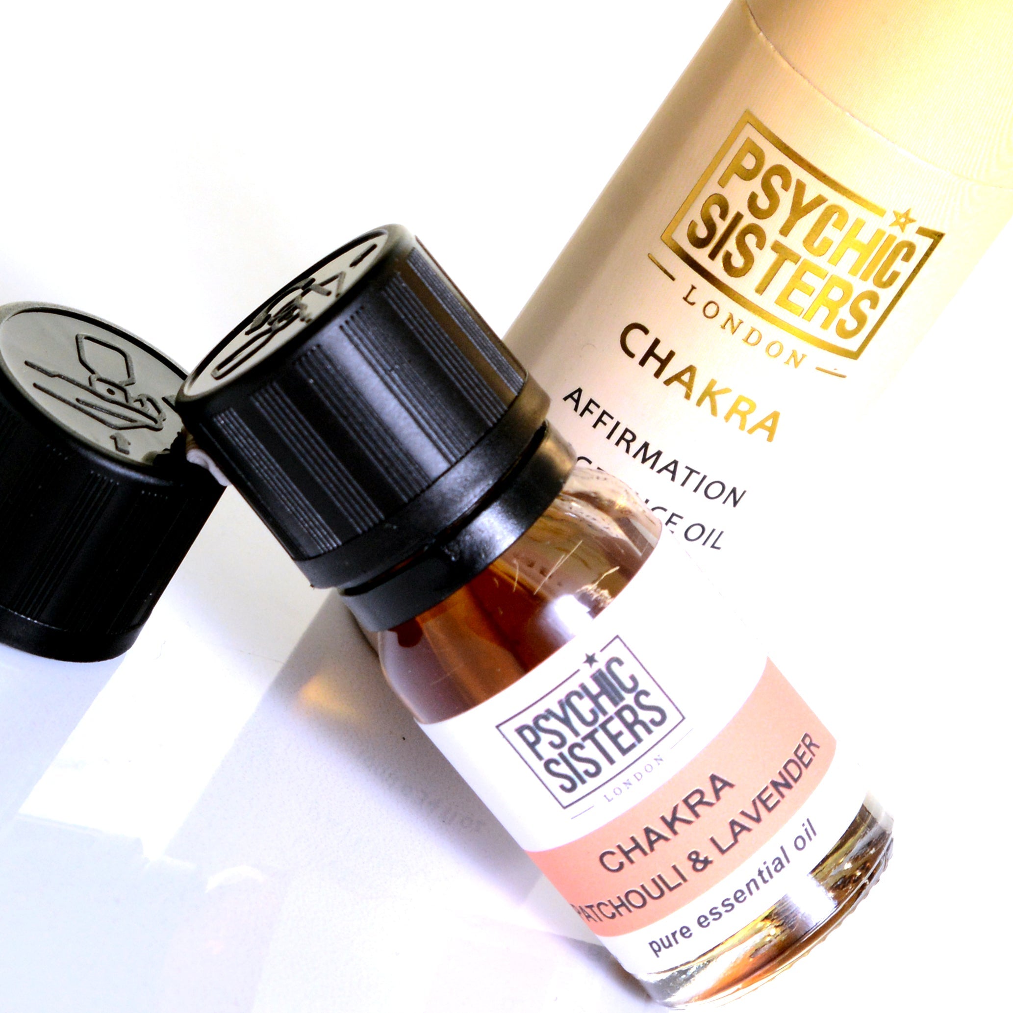 Chakra fragrance oil bottle featuring Psychic Sisters brand, highlighting the patchouli and lavender scent.